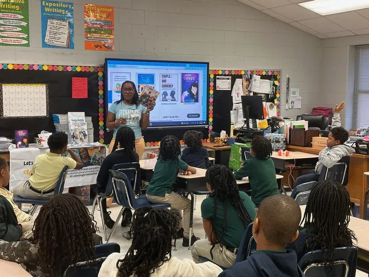 Classroom visit with book covers on screen