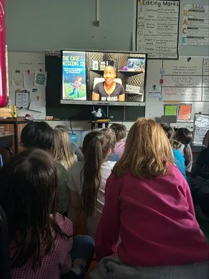 Students watching the author visit on screen